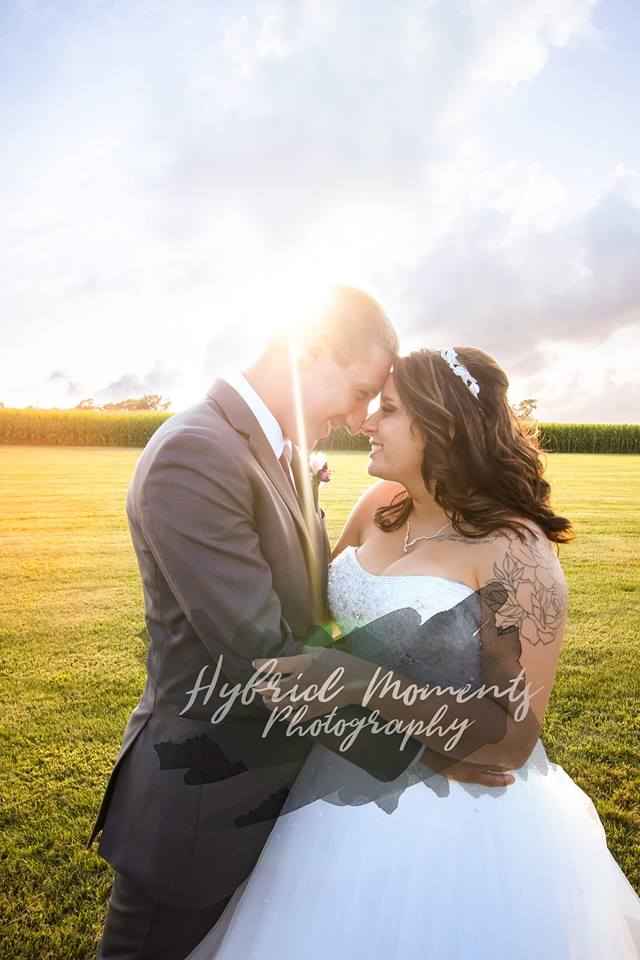 Hybrid Moments Photography Barn Weddings are popular right now. Couple outside of a barn by a field