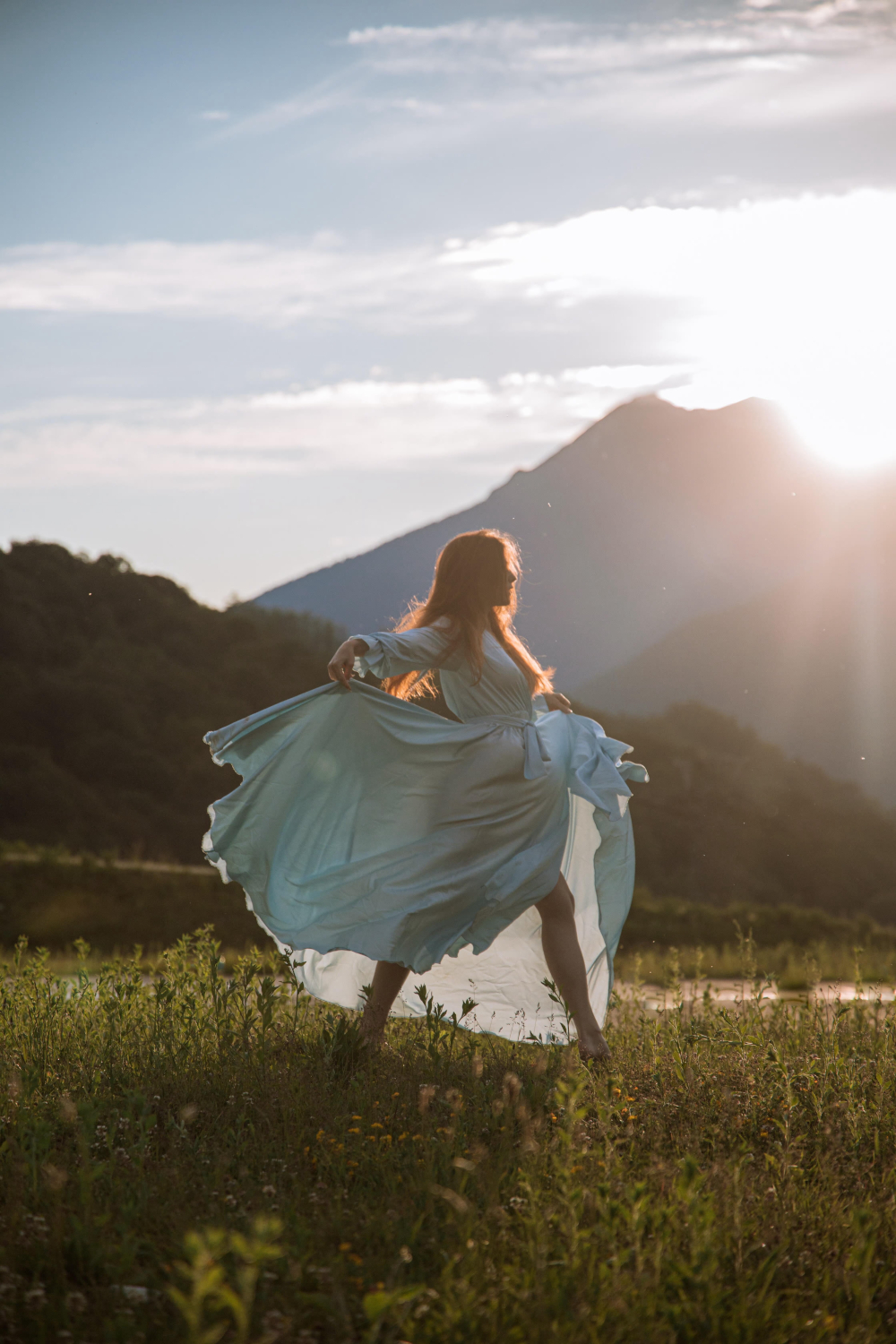 Female Dancing with mountain in background. This image is decorative purposes this is used as a link to for First dance song suggestions for 2023 couples 